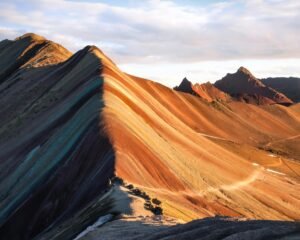 Rainbow Mountain in Peru features vibrant colors from natural mineral deposits.