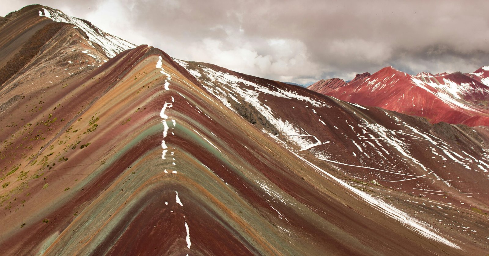 Stunning view of the vibrant Rainbow Mountain in Cusco, Peru, showcasing its vibrant colors and unique geological formations.