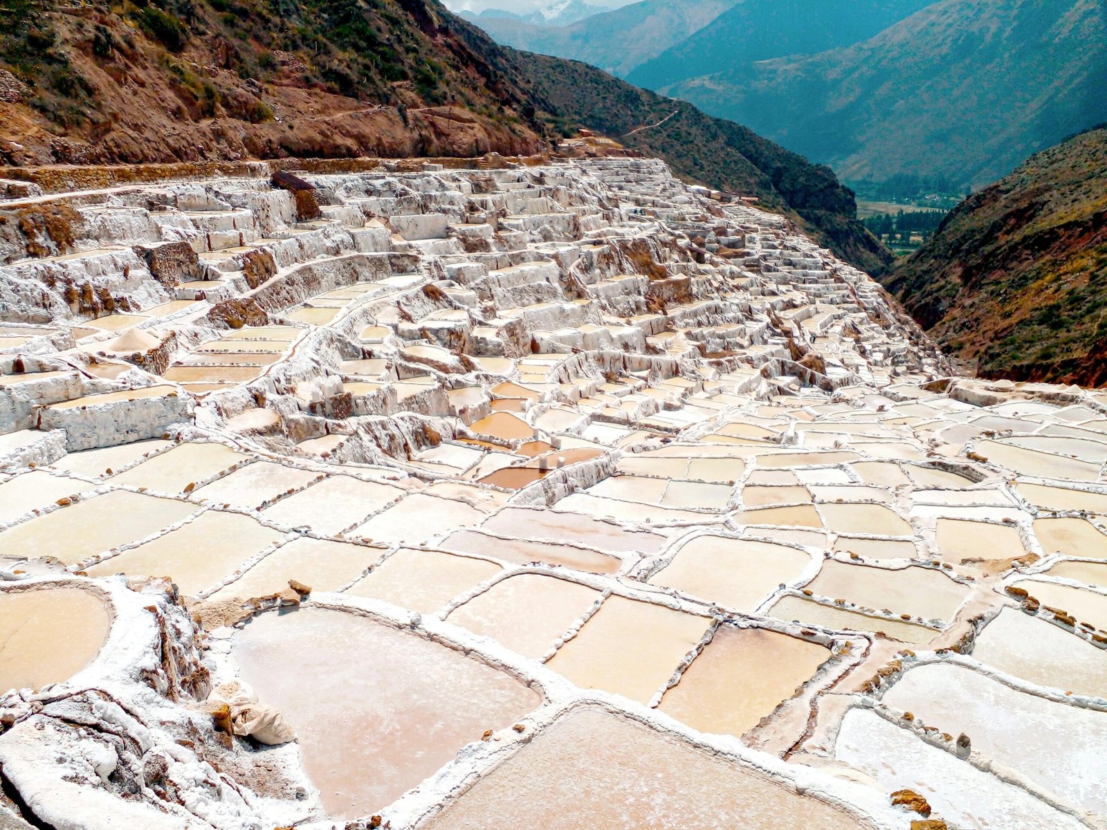 Scenic aerial view of the historic salt ponds of Maras, nestled in the Andes near Cusco, Peru.