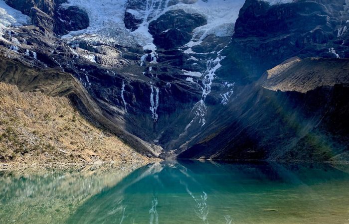 Stunning view of Humantay Lake with snow-capped mountains in Cusco, Peru.